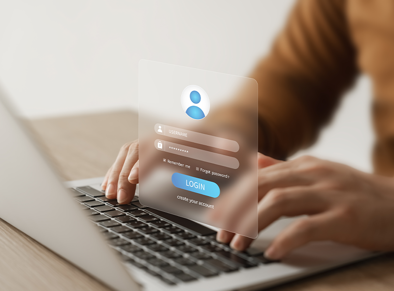 "Mann tippt auf Laptop, vor ihm schwebt ein imaginäres Login-Pop-up